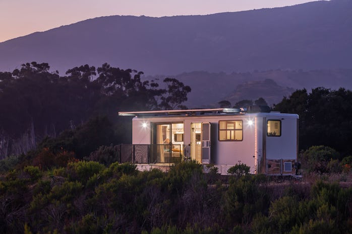 A Living Vehicle trailer home at dusk.