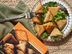 Trader Joe's Spicy Pumpkin Samosas sit on a colorful plate during the fall.