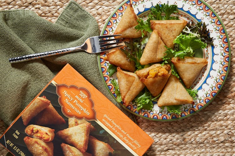 Trader Joe's Spicy Pumpkin Samosas sit on a colorful plate during the fall.