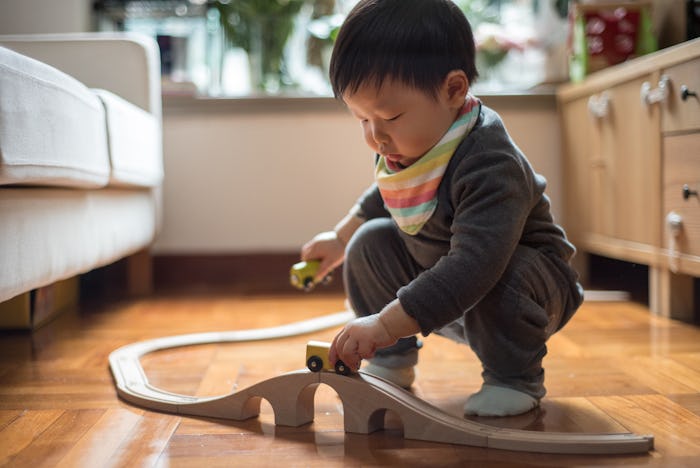 baby boy playing with train