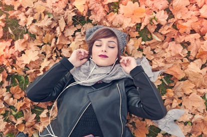 Young woman listening to music in fall