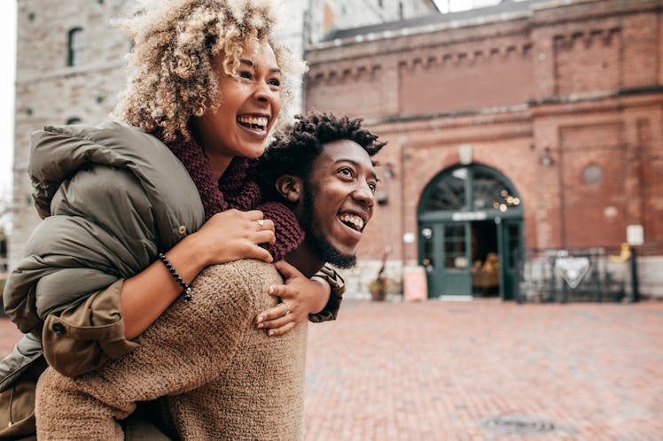 Young couple piggybacking in fall