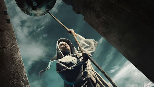 GEMMA ARTERTON as Sister Cloddagh in a nun's habit with a staff against a dark spooky-looking sky