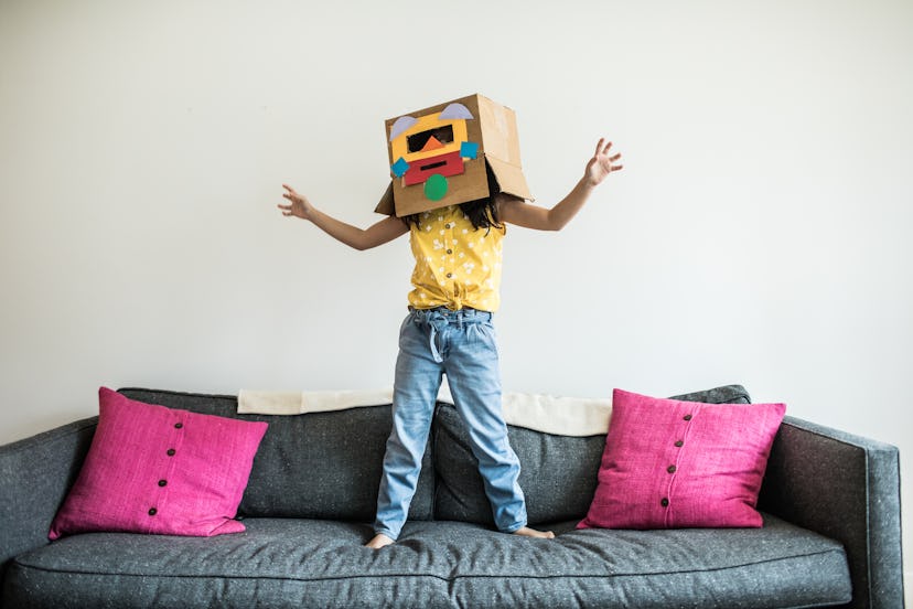child playing on couch in robot costume