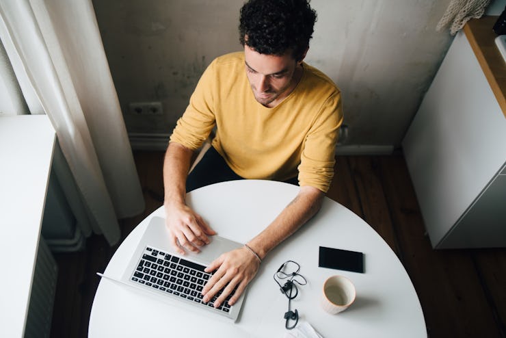 Man working from home at table.