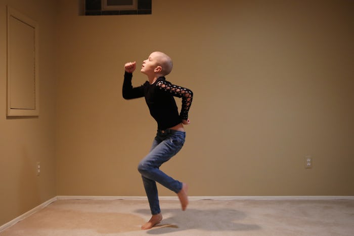 child with cancer dancing in her living room