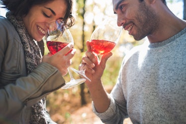 Young couple drinking wine in fall