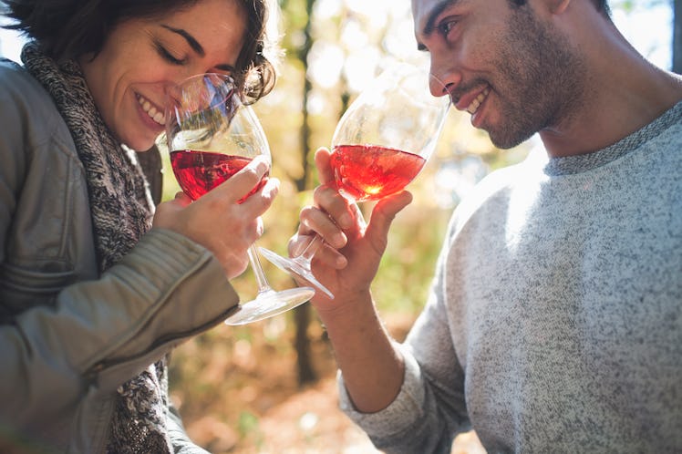 Young couple drinking wine in fall