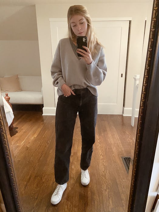 Style gray jeans with a slouchy sweater and sneakers when working from home