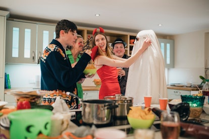 Friends laughing, eating on Halloween