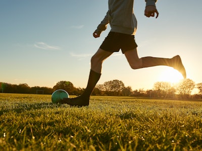 Man playing soccer in a field.