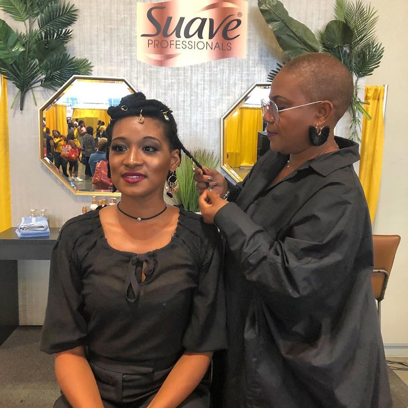 A woman getting her hair done by a hairstylist who knows how to properly take care of black hair