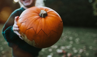 kid with a pumpkin