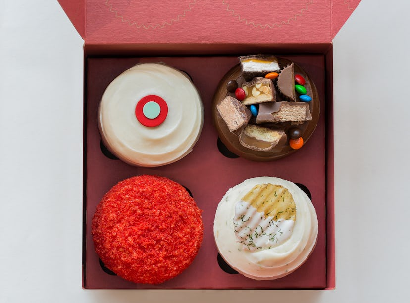 promo image of Sprinkles Pregnant AF box; closeup of each of the four cupcakes in a red box