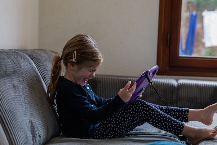 little girl screaming in frustration at tablet