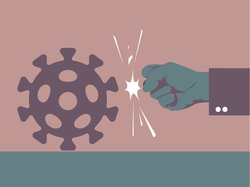 Hand punching a virus.