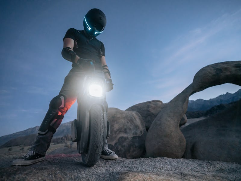 A person in a helmet with an electric unicycle