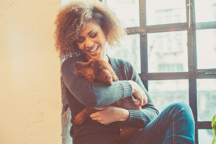 Young woman playing with dog