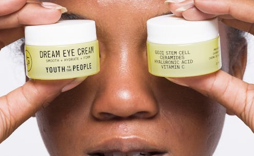 Youth To The People's Dream Eye Cream held by model.