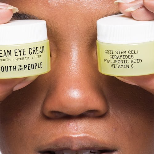 Youth To The People's Dream Eye Cream held by model.