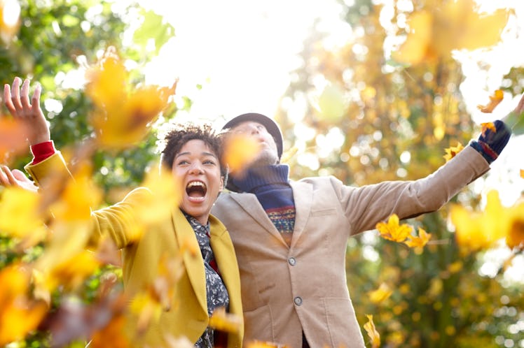 Young couple in fall leaves