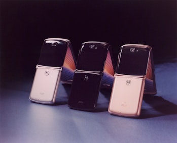 Three Motorola Razrs propped up.