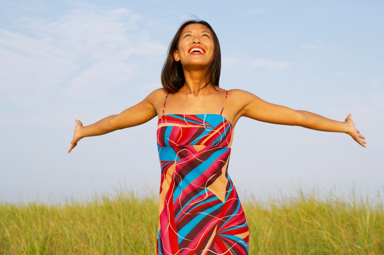 Young woman with arms outstretched