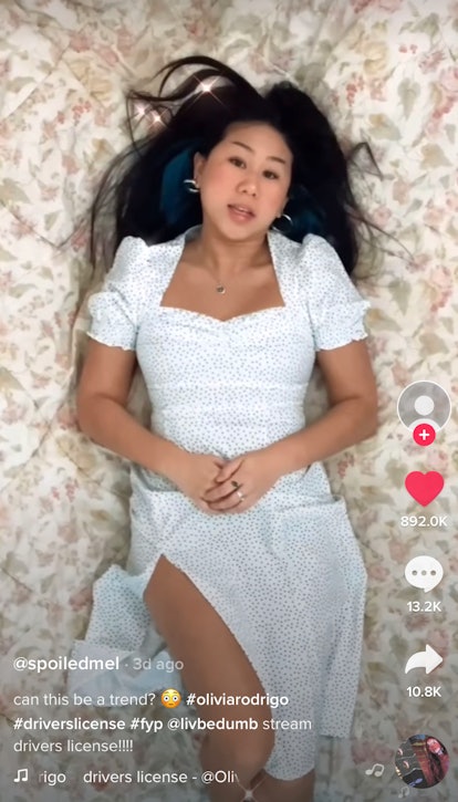 A girl lays on her bed singing to "driver's license" by Olivia Rodrigo for TikTok. 