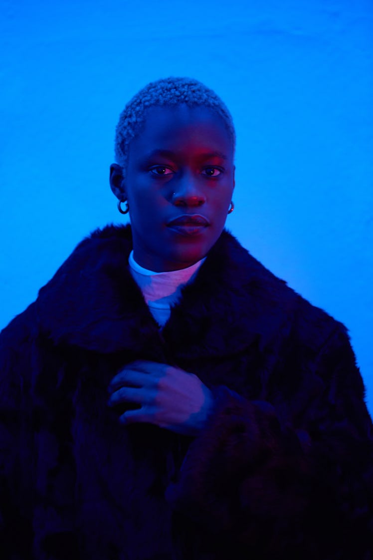 Portrait of young woman in neon light