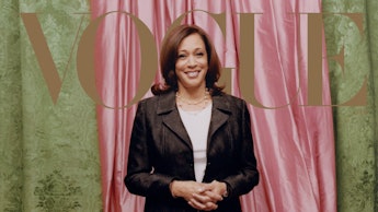 Kamala Harris posing for vogue in a black blazer a grey shirt and sneakers, in front of a pink curta...