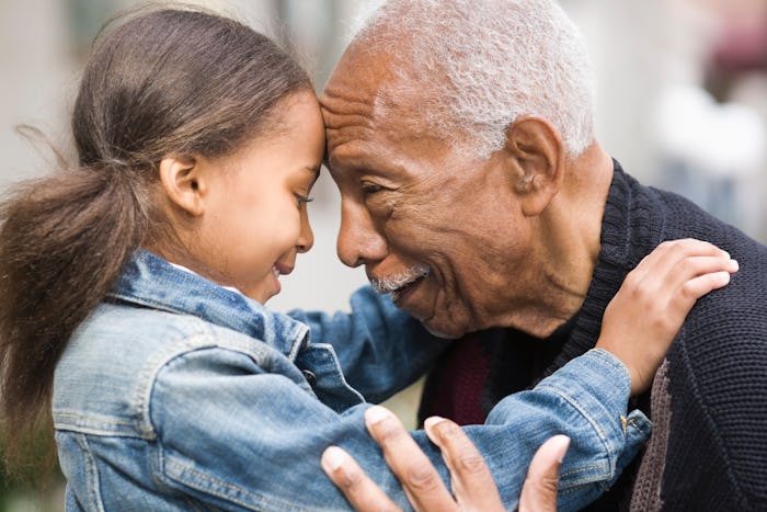 young girl and grandfather forehead to forehead 