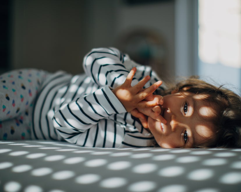 young child lying down in bed