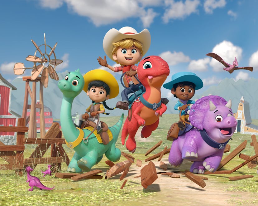 Three children, dressed as cowboys and a cowgirl, ride on the backs of friendly, colorful cartoon di...