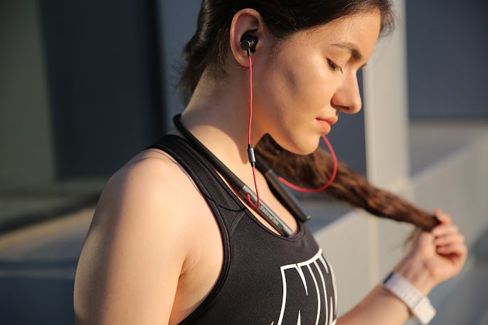 A woman wearing Finalace headphones