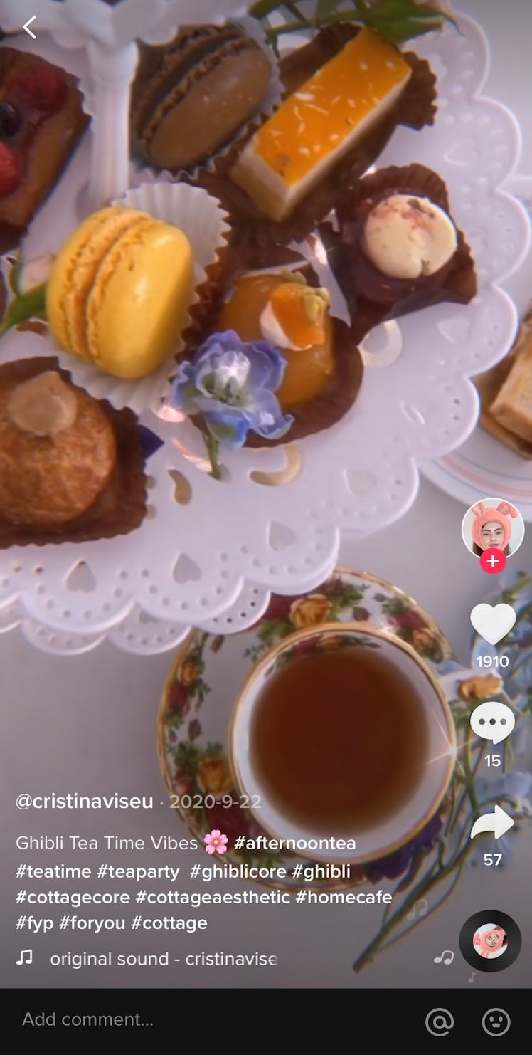 A TikTok video shows an afternoon tea spread complete with pastries, flowers, and tea.