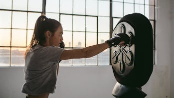 A women punches at a Liteboxer