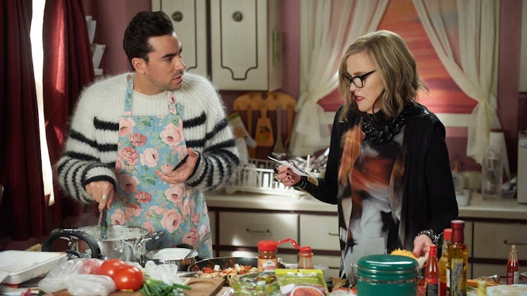 David Rose and Moira fold in the cheese of their enchiladas in the kitchen on 'Schitt's Creek.'