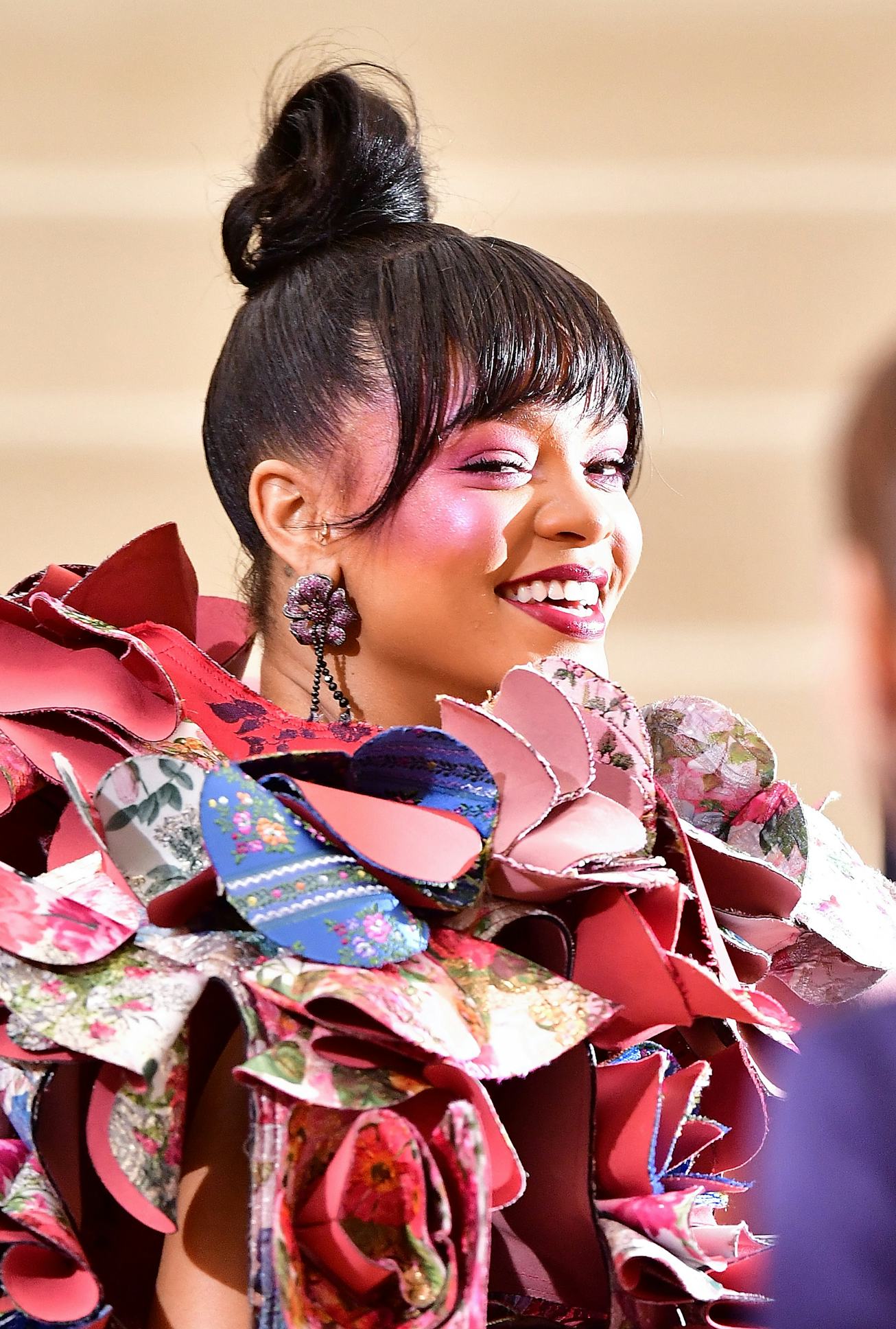 Rihanna at the 2017 Met Gala in a red-blue-white Comme des Garcons dress with 3D patchwork flower el...