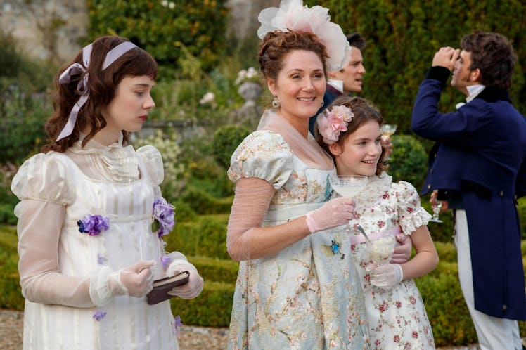 Lady Violet Bridgerton walks in the garden with her daughters, Eloise and Hyacinth, in 'Bridgerton.'