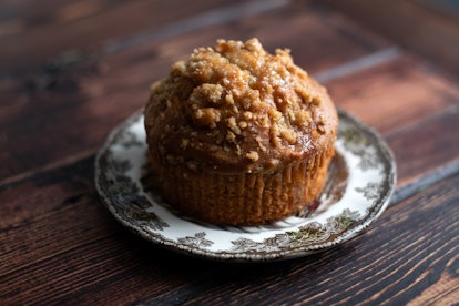 Apple and cinnamon brown muffin served on a small plate