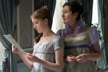 Lady Violet Bridgerton and Daphne Bridgerton stand by the window reading Lady Whistledown's gossip s...