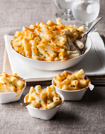 Macaroni cheese served in three small and one big plate
