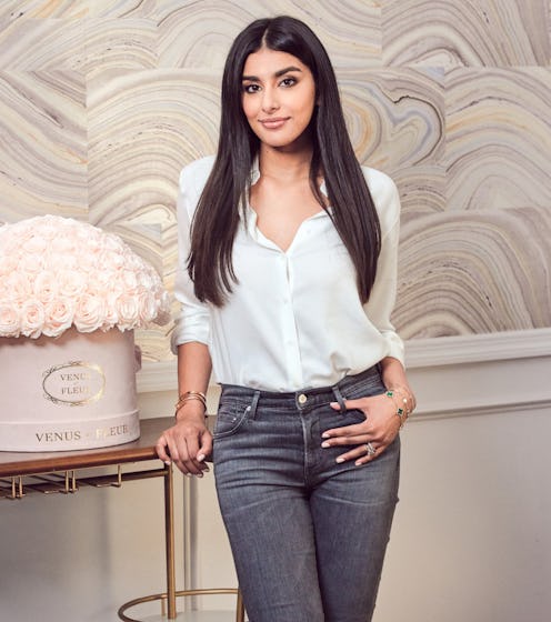 Seema Bansal Chadha posing next to the white roses from Venus et Fleur