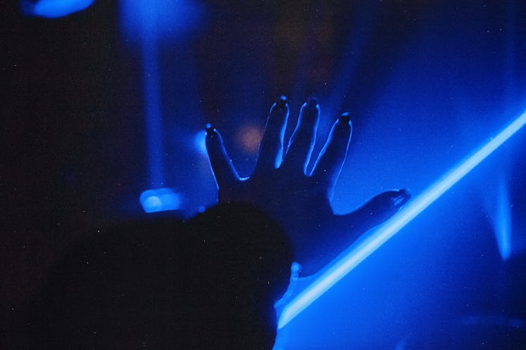 Human Hand On Blue Neon Background
