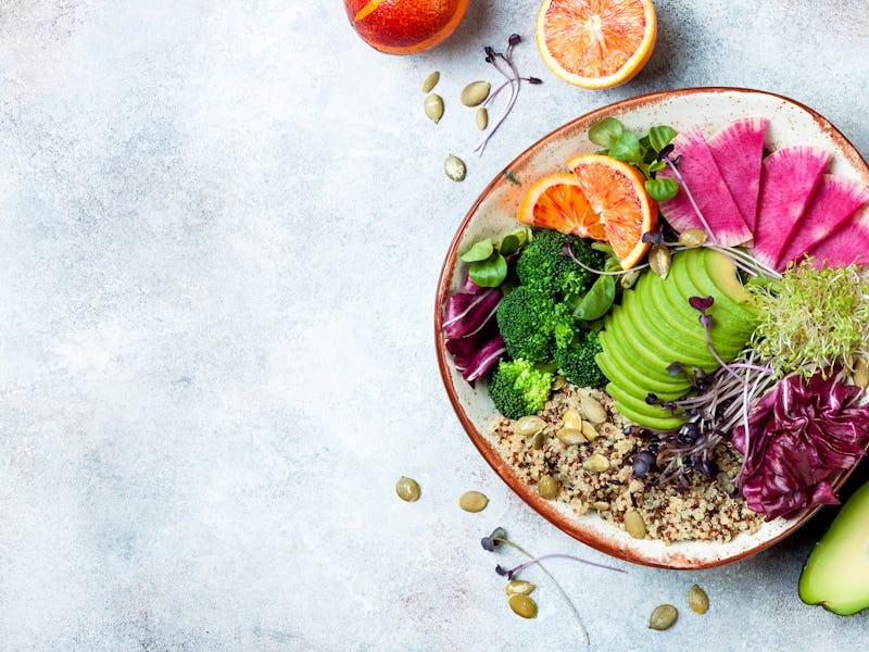 Vegan, detox Buddha bowl with quinoa, micro greens, avocado, blood orange, broccoli, watermelon radi...