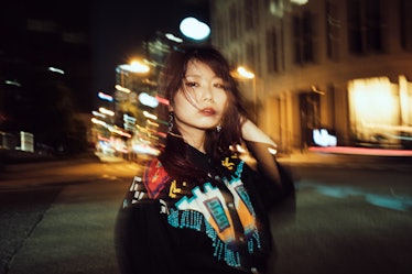 Portrait of contemporary young Japanese woman at night street