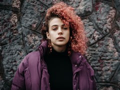 Young woman with pink curly hair