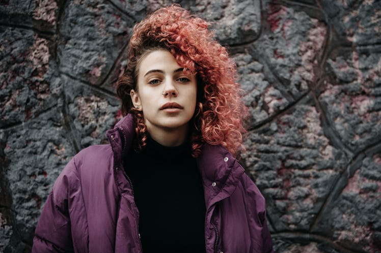 Young woman with pink curly hair