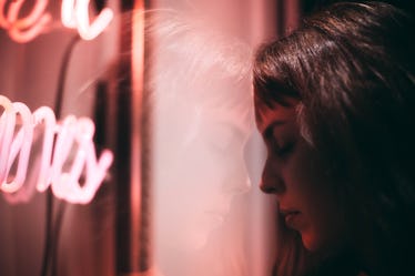 Reflection Of Thoughtful Woman On Window Glass