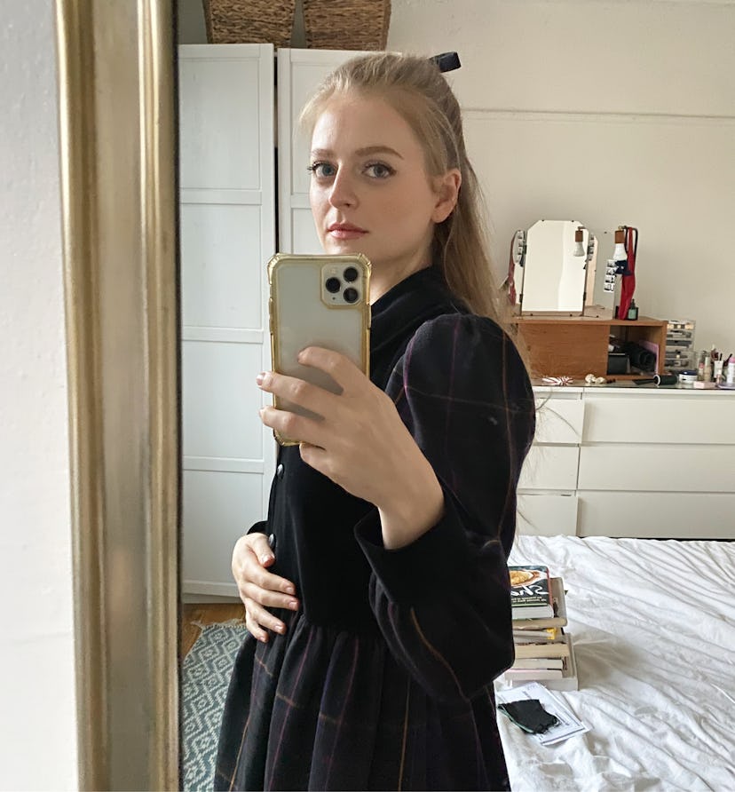 Anna Baryshnikov taking a mirror photo while in a black dress
